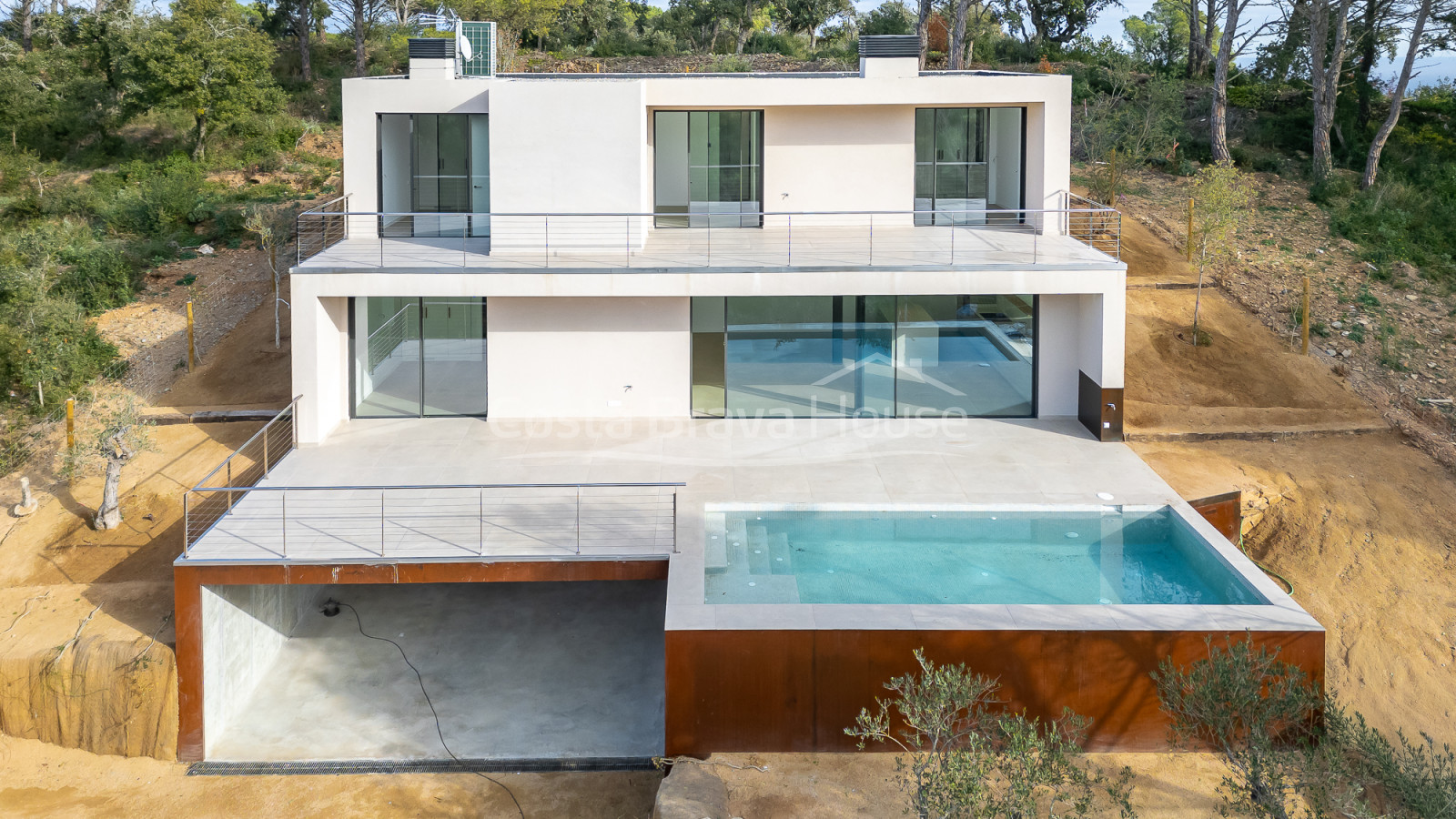 Casa de obra nueva en Begur con piscina infinita, terrazas, diseño moderno y vistas abiertas